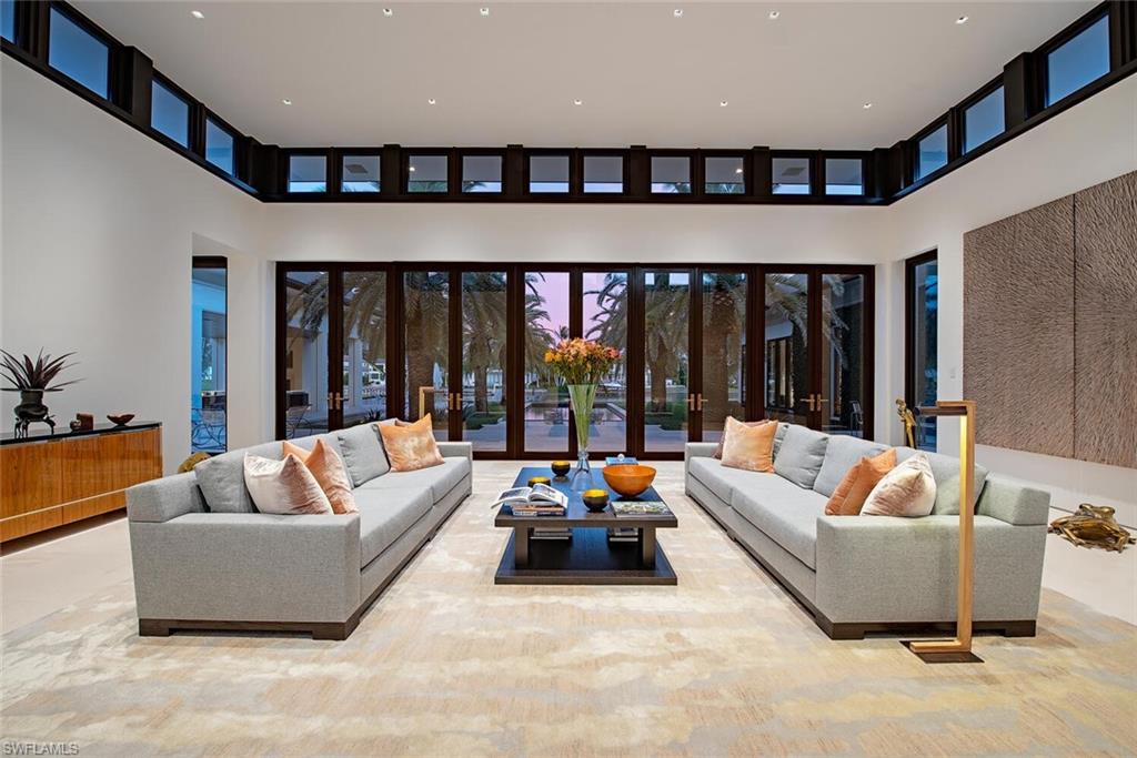 3655 Fort Charles Drive Naples, FL 34102 - Photo 10 of 50 a living room with furniture and large windows