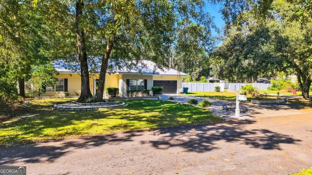 an aerial view of a house with a garden and a yard