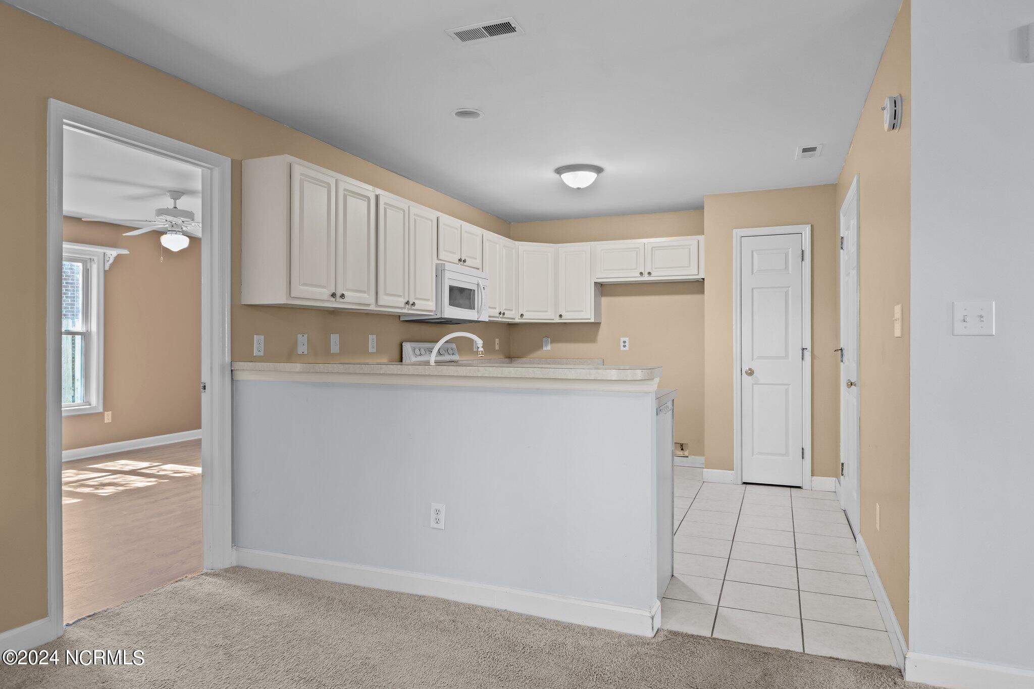404 Commerce Avenue, Unit B Morehead City, NC 28557 - Photo 16 of 46 Kitchen and Primary Bedroom Door