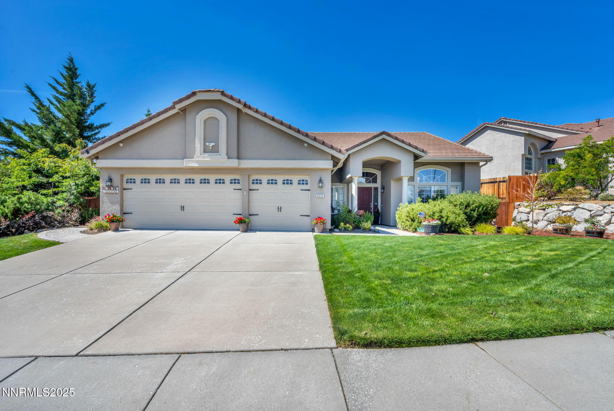 a front view of a house with a garden