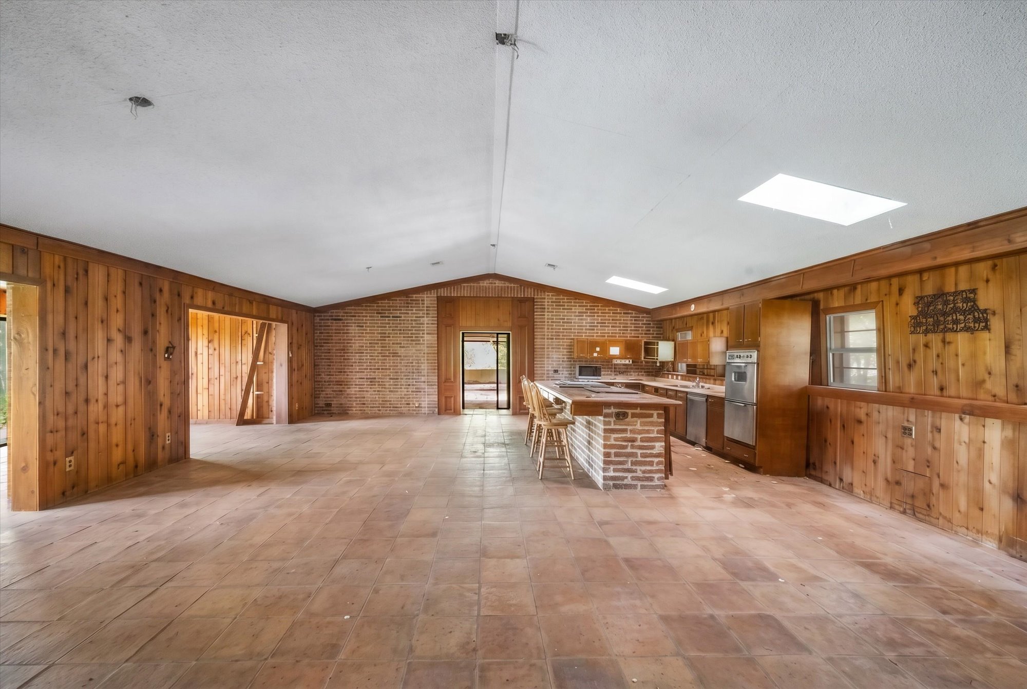14201 Lund - Carlson Road Coupland, TX 78615 - Photo 29 of 40 A spacious kitchen featuring brick and wood accents, perfect for entertaining.