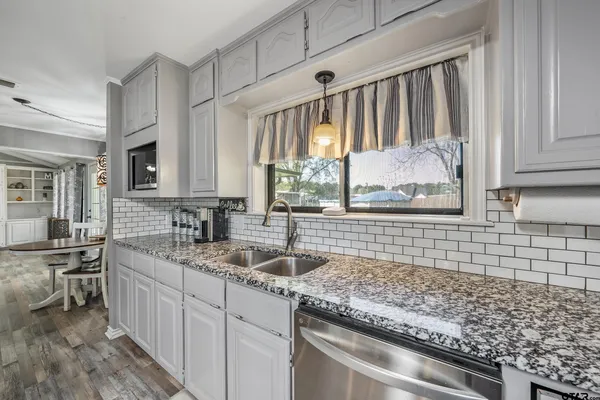 a kitchen with a sink stove and cabinets