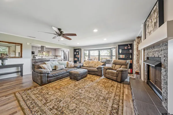 a living room with furniture fireplace and a large window