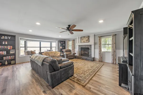 a living room with furniture fireplace and a window