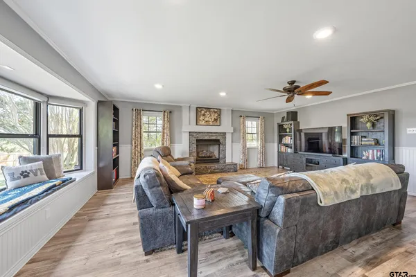 a living room with furniture fireplace and flat screen tv