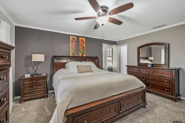 a bedroom with a bed and a dresser