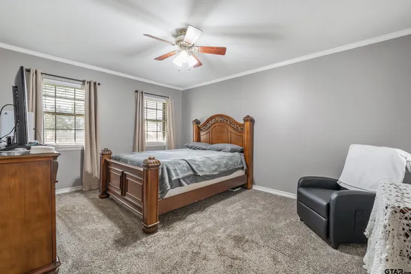 a bedroom with a bed couch and window