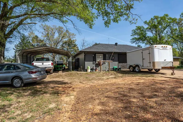 a front view of a house with a garden and parking