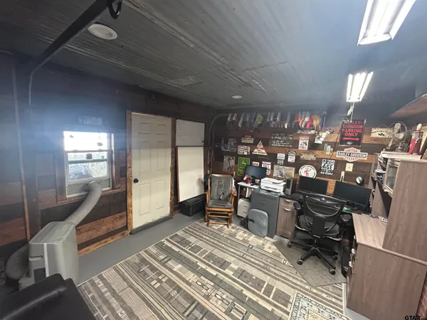 a room with lots of wooden furniture and a rug