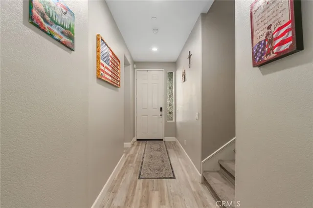 a view of a hallway with wooden floor