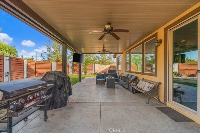 a living room with furniture and a floor to ceiling window