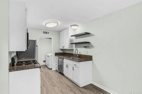 a kitchen with stainless steel appliances granite countertop a stove and a sink
