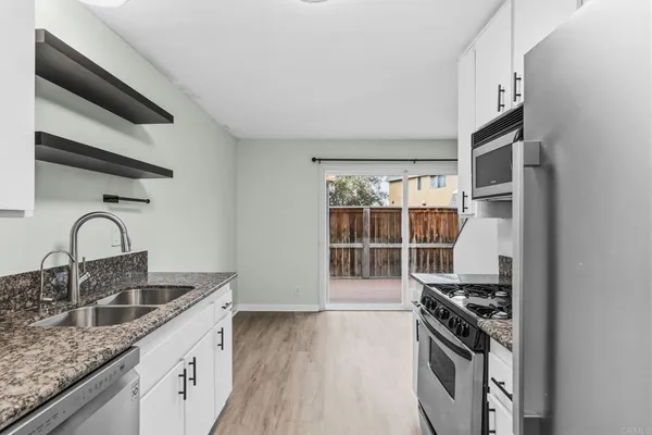 a kitchen with stainless steel appliances granite countertop a stove and a sink