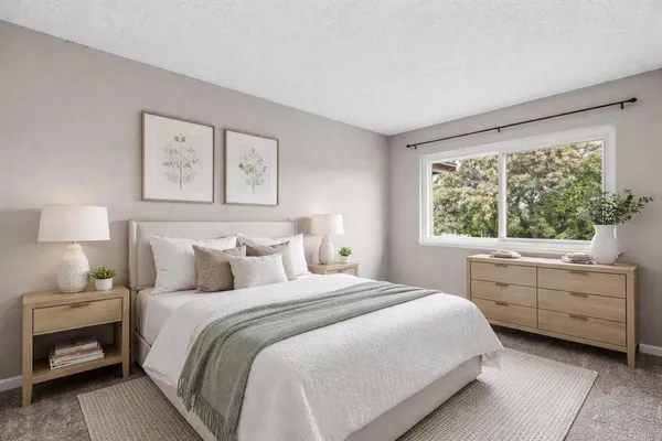 a bedroom with a bed and a window