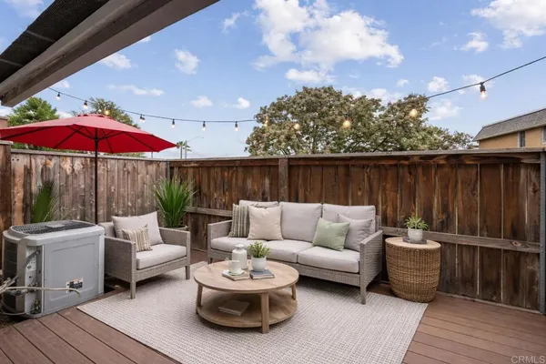 a view of a patio with couches and pool