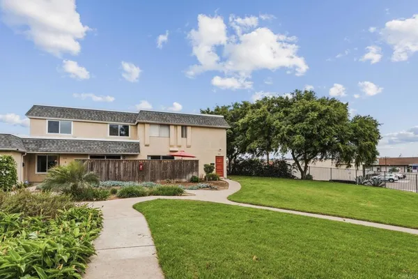 a view of a house with a backyard
