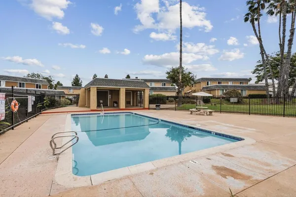 a house view with swimming pool and sitting space