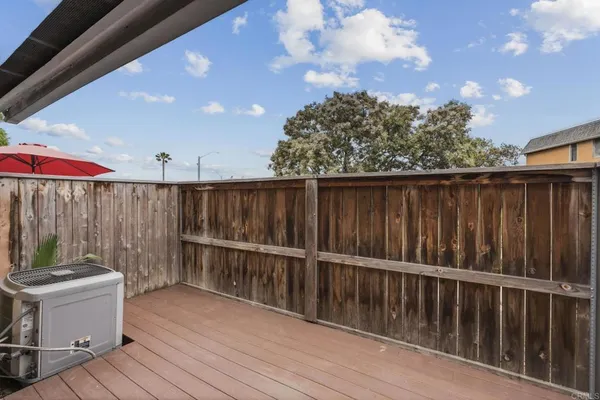 a view of a roof deck with wooden fence