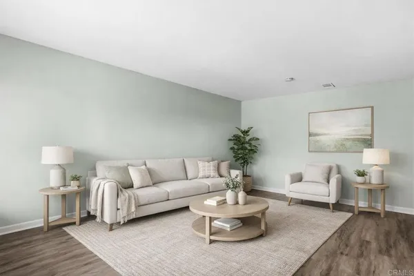 a living room with furniture and a potted plant on table