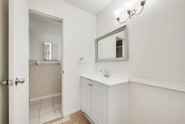 a bathroom with a sink a mirror and vanity