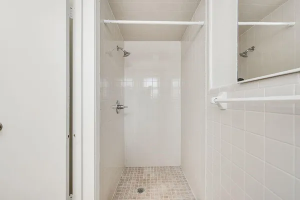a bathroom with a glass shower door