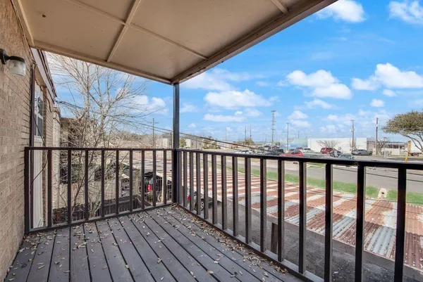 a view of a balcony with wooden floor