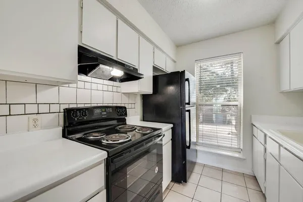 a kitchen with a stove and a refrigerator