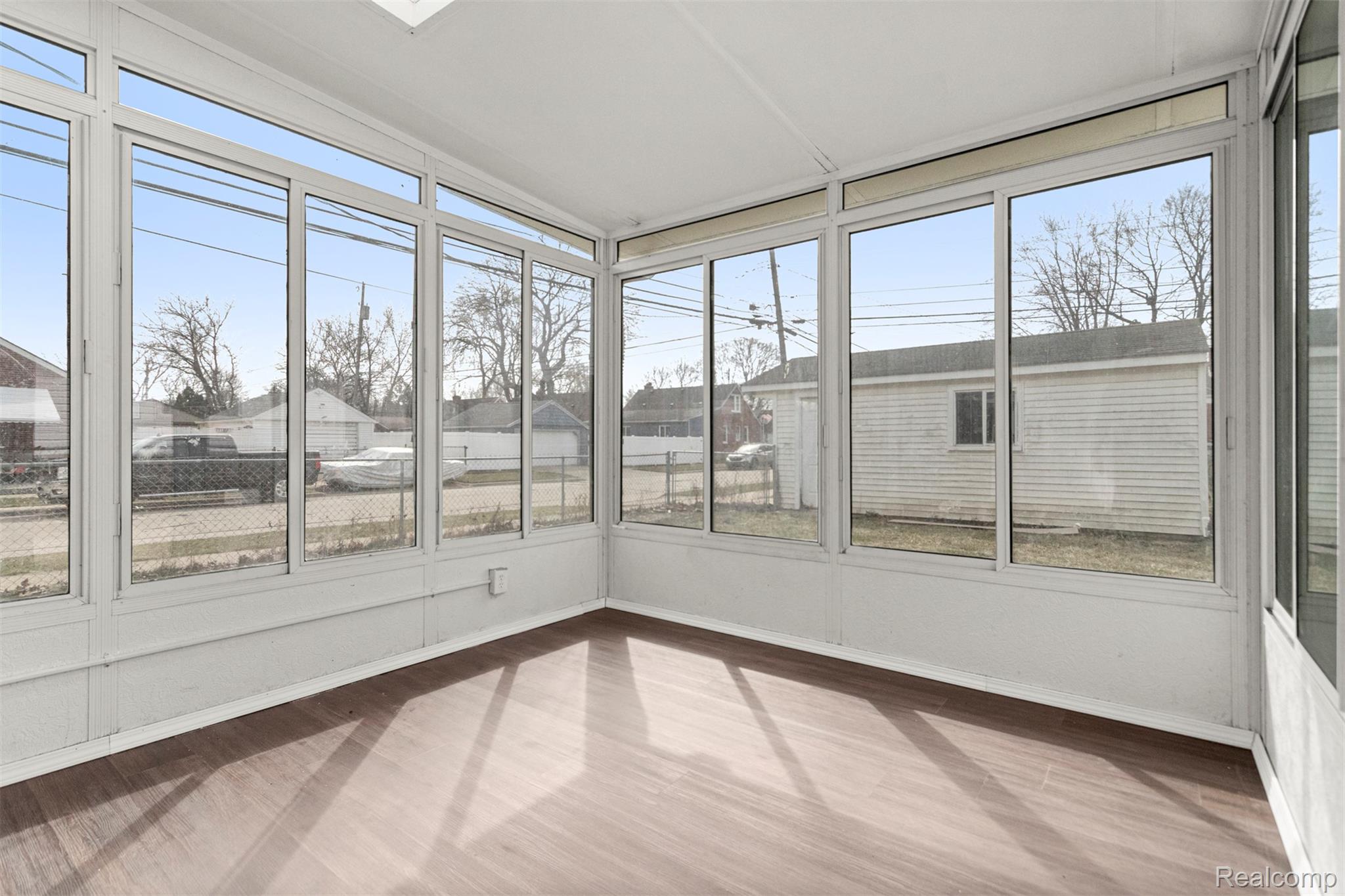 15705 Champaign Road Allen Park, MI 48101 - Photo 33 of 42 Unfurnished sunroom featuring wood finished floors and a residential view