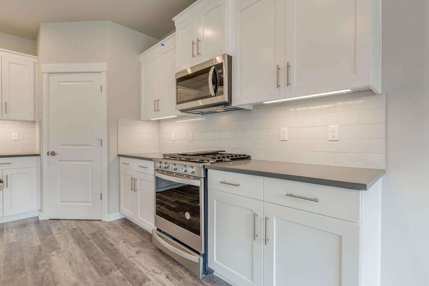 4620 Southwest 36th Street Redmond, OR 97756 - Photo 12 of 22 Kitchen has quartz countertops, full-height backsplash, solid Alder cabinets, large corner pantry. PSimilar property photo with the same floorplan. Finishes and specs vary.