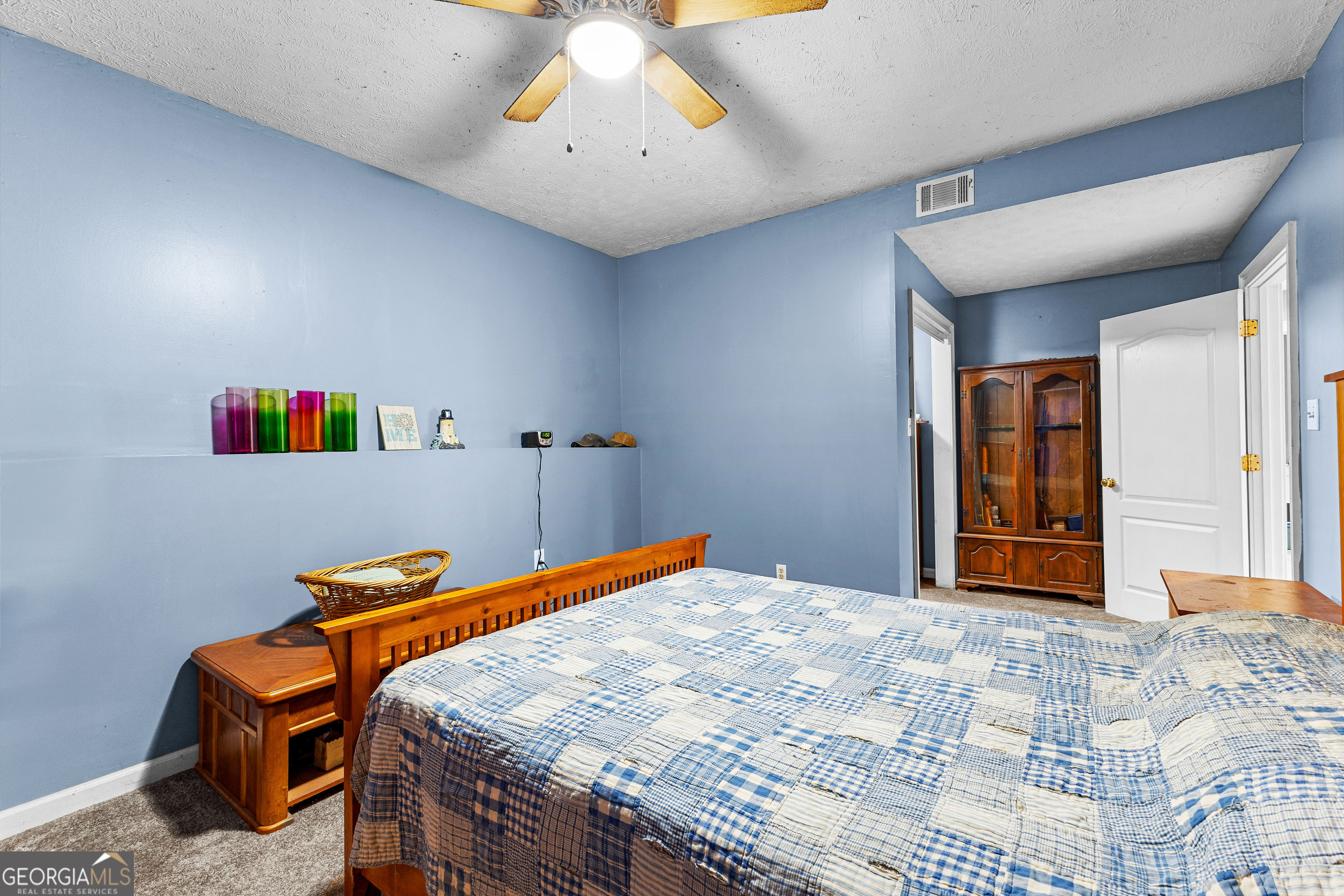 502 North Rover Road Williamson, GA 30292 - Photo 19 of 46 a bedroom with a bed and a chandelier