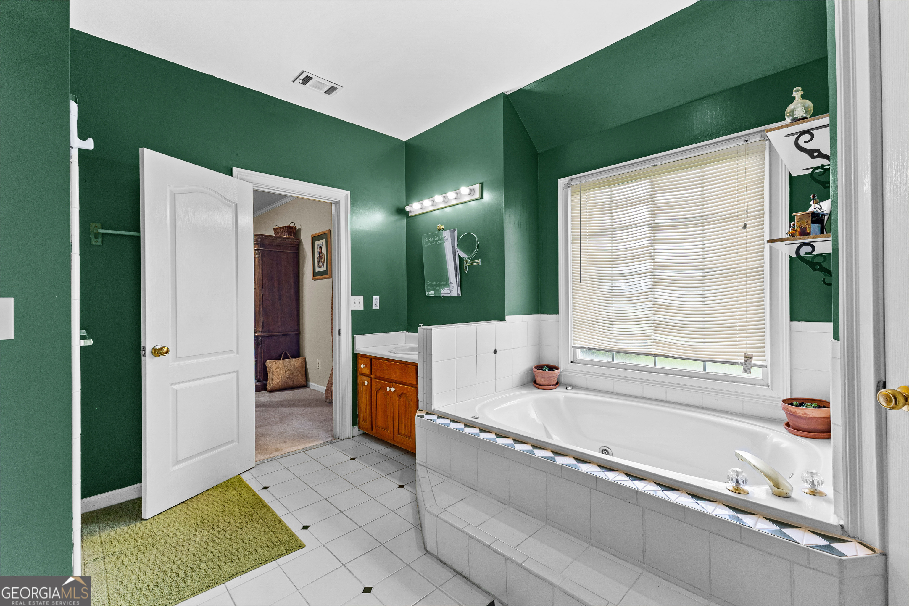 502 North Rover Road Williamson, GA 30292 - Photo 27 of 46 a bathroom with a tub a sink and a large mirror