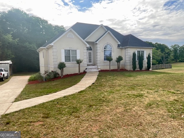 502 North Rover Road Williamson, GA 30292 - Photo 41 of 46 a front view of a house with a yard and garage