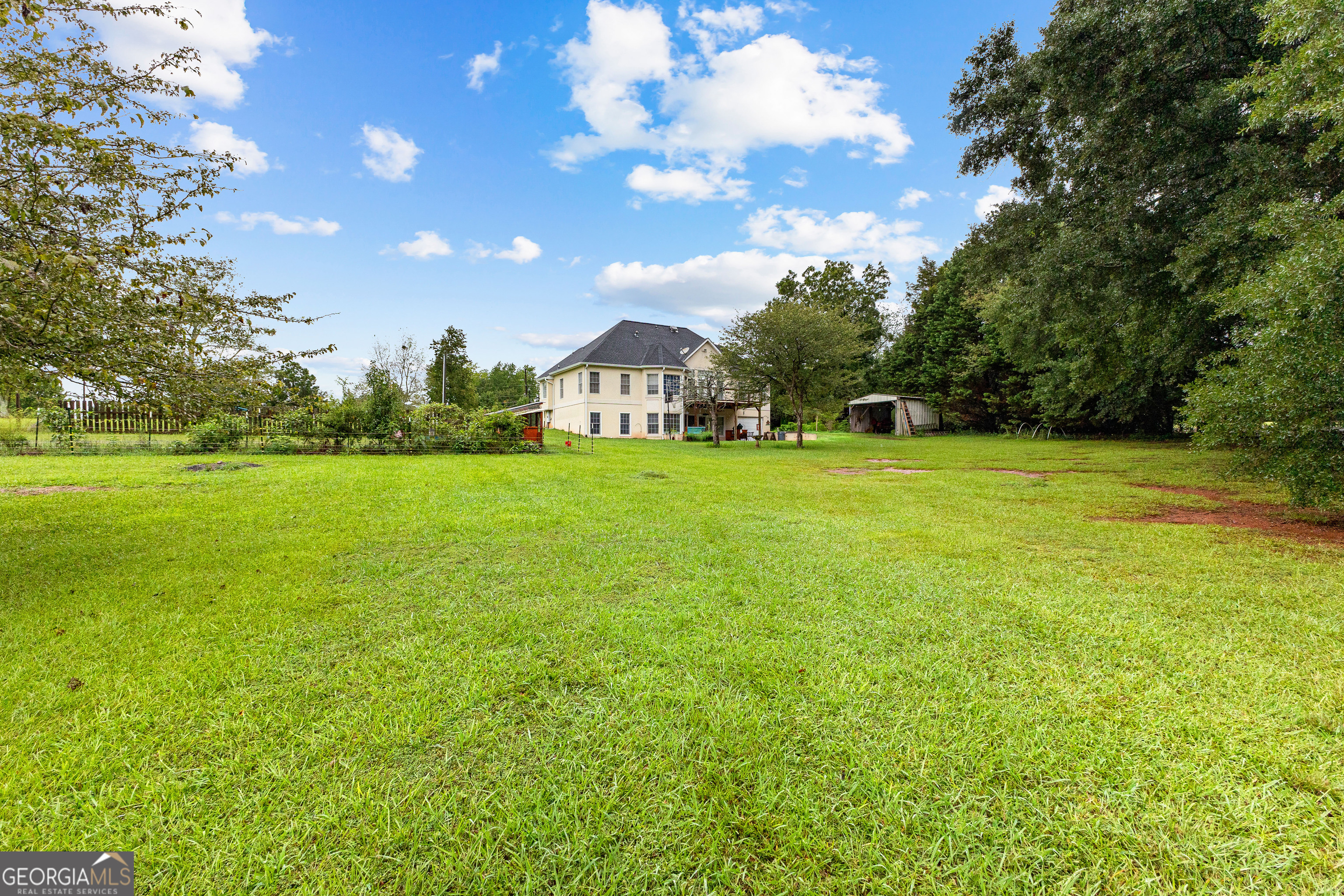 502 North Rover Road Williamson, GA 30292 - Photo 8 of 46 a view of a green field with trees in the background