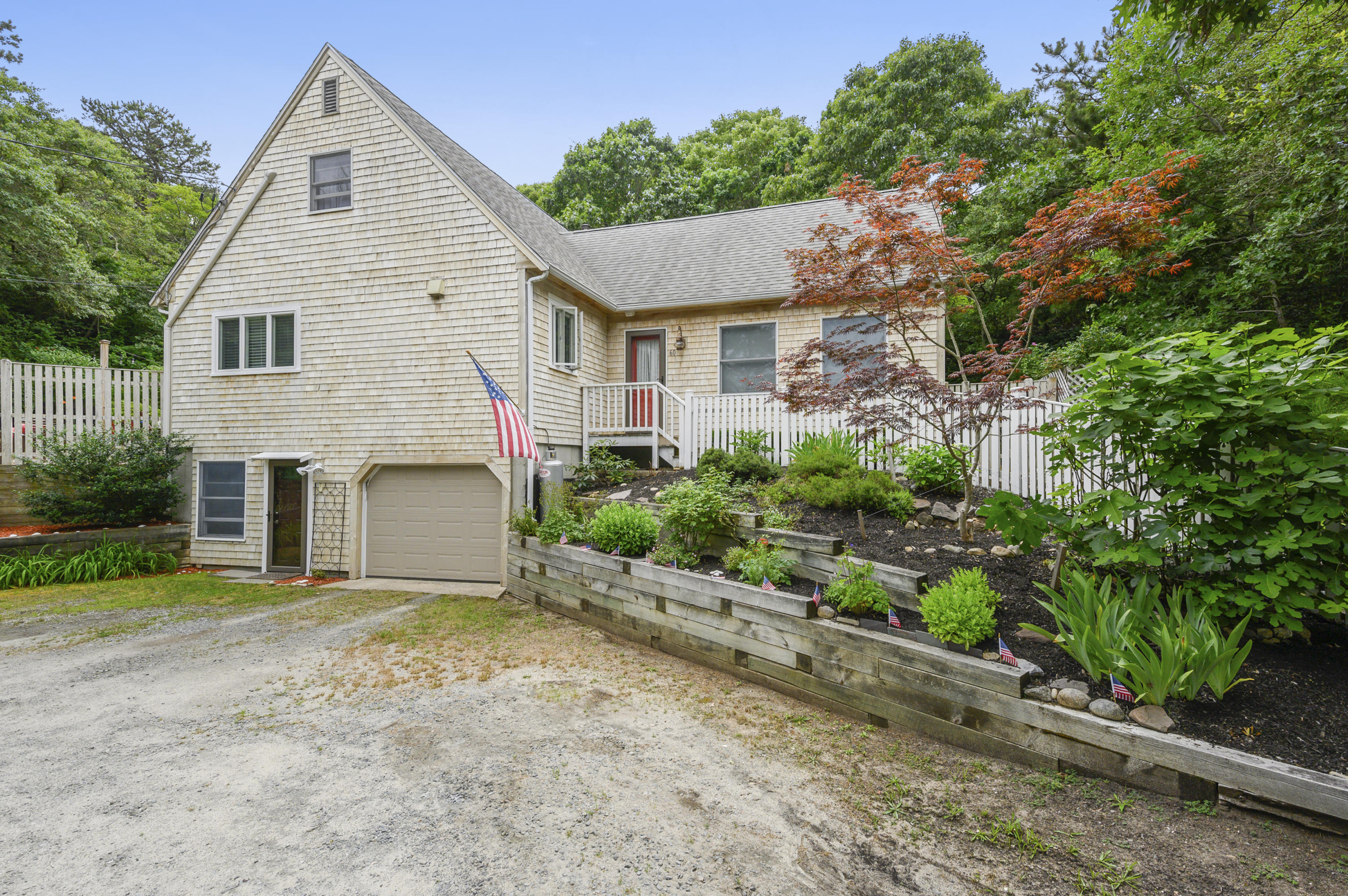 60 Truro Center Road Truro, MA 02666 - Photo 1 of 30 a view of a white house with a yard and potted plants