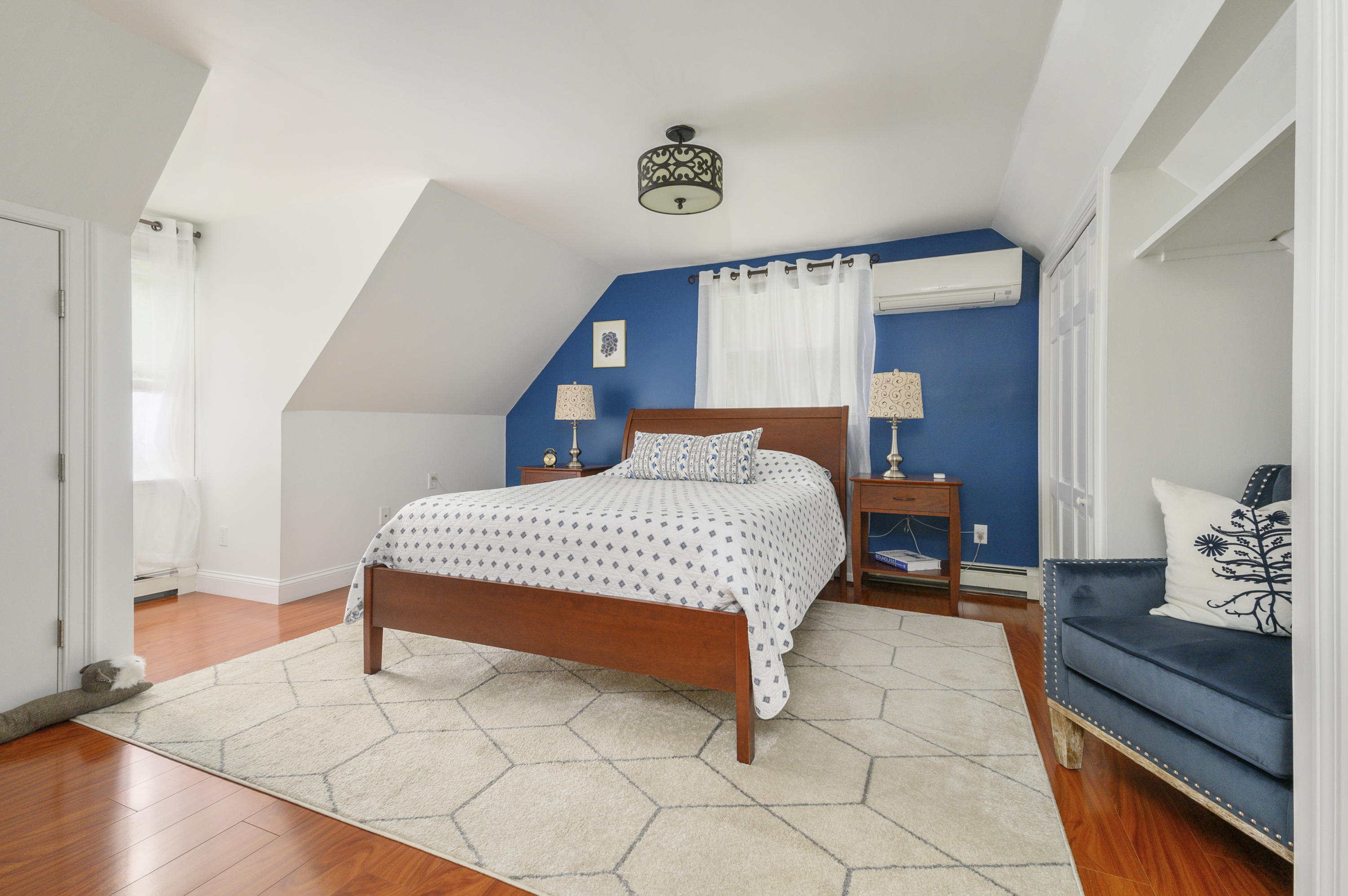60 Truro Center Road Truro, MA 02666 - Photo 18 of 30 a bedroom with a bed and a window with wooden floor