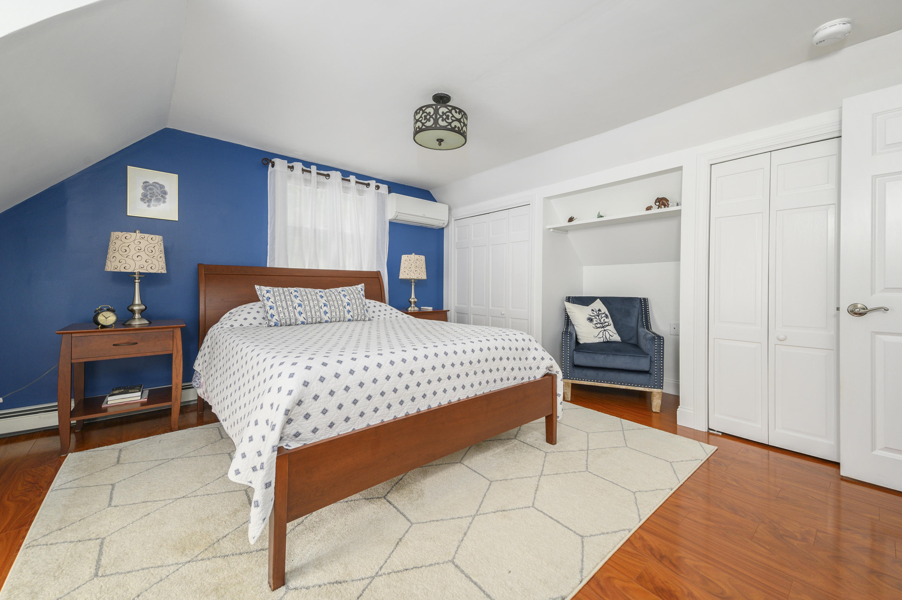 60 Truro Center Road Truro, MA 02666 - Photo 19 of 30 a bedroom with a bed and a table in it