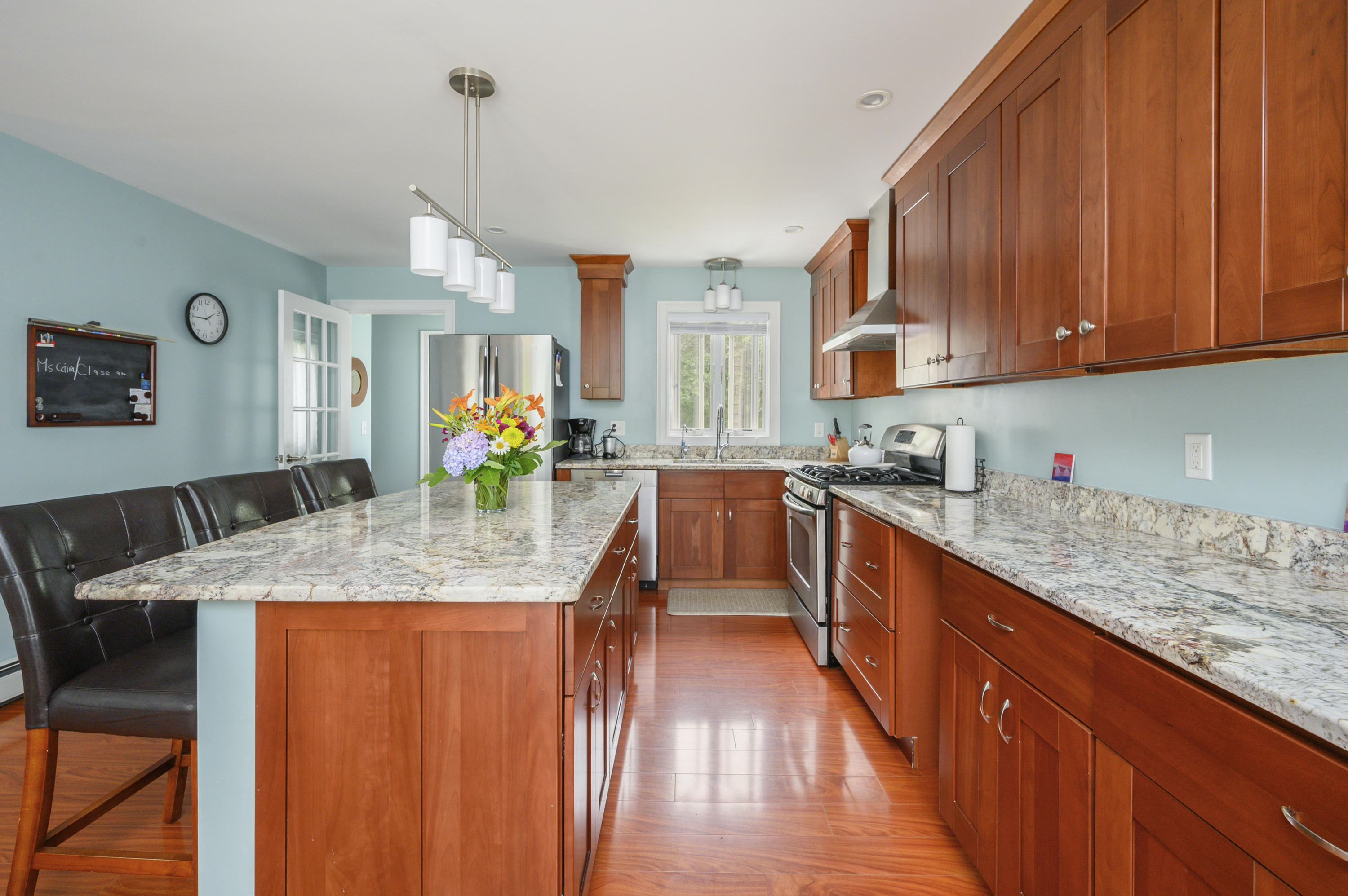 60 Truro Center Road Truro, MA 02666 - Photo 8 of 30 a kitchen with stainless steel appliances granite countertop wooden cabinets a sink dishwasher and a stove with wooden floor