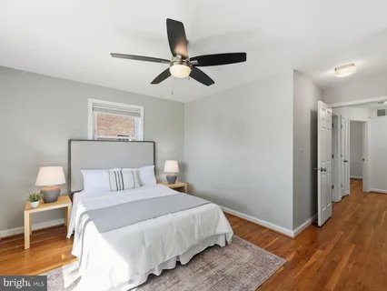 a bedroom with a bed and a ceiling fan