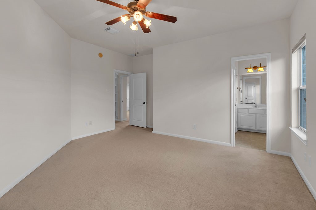 7306 Starflower Katy, TX 77494 - Photo 42 of 50 an empty room with chandelier fan and windows