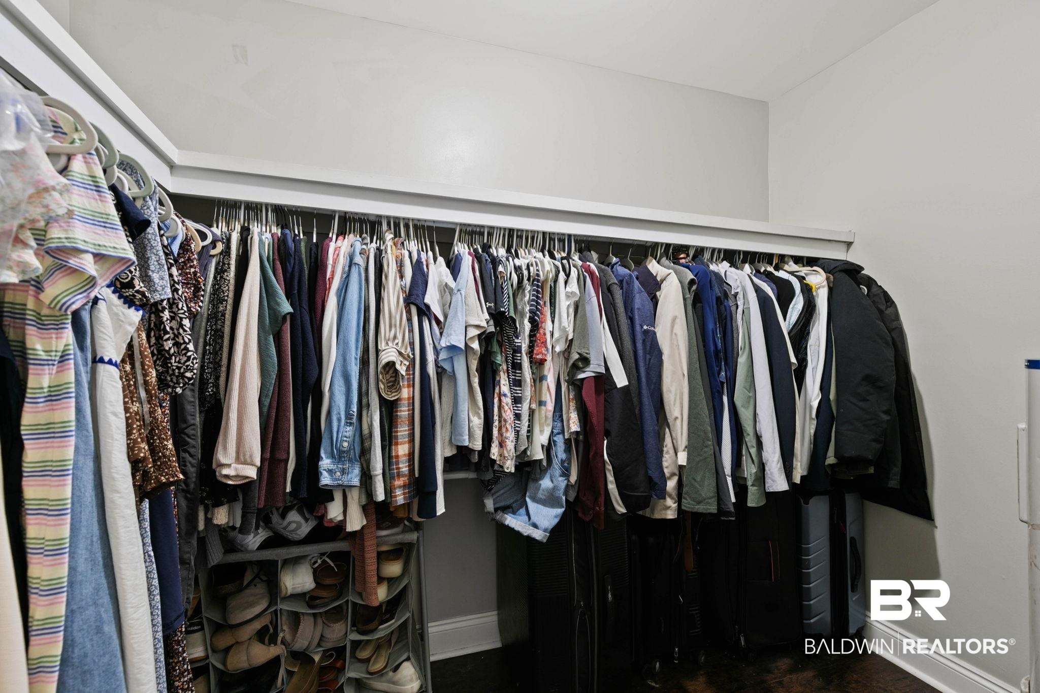 22810 High Ridge Road Fairhope, AL 36532 - Photo 39 of 78 Custom closet system featuring multiple hanging rods and integrated shelving for organized storage