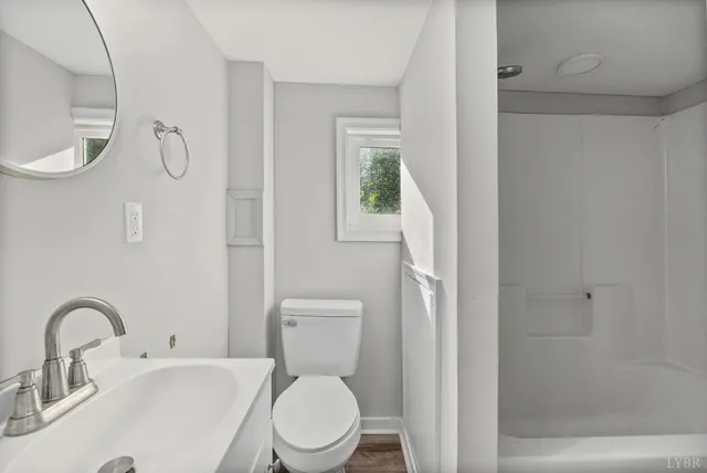 a white toilet sitting next to a bathroom sink