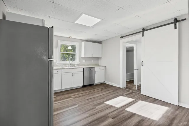 a kitchen with a sink window and cabinets