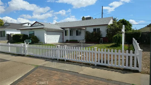 a front view of a house with wooden fence