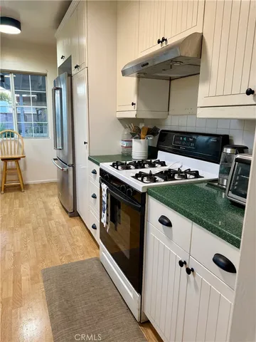 a kitchen with stainless steel appliances granite countertop a stove and a refrigerator