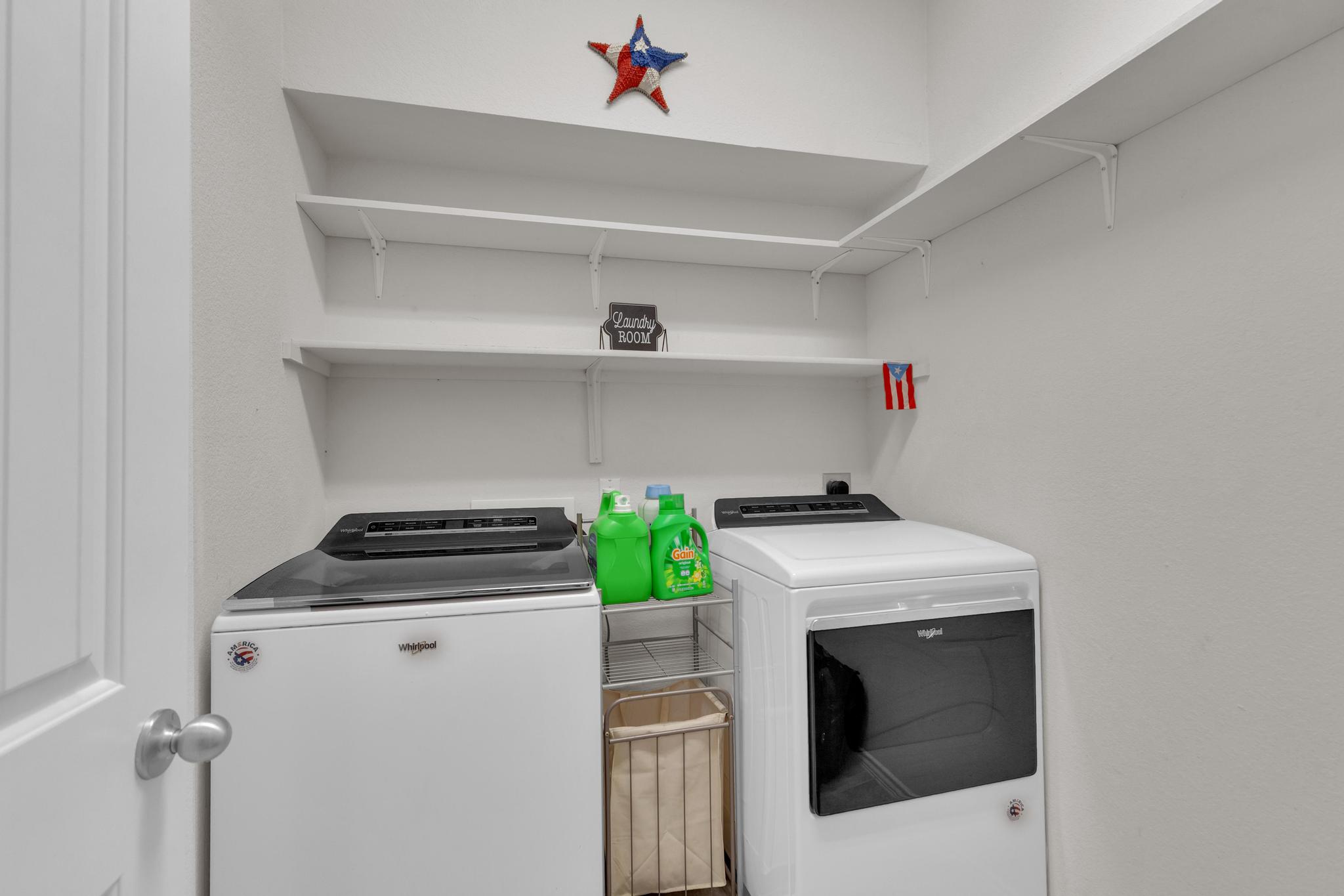 104 Uncle Billy Way Jarrell, TX 76537 - Photo 21 of 38 Ample shelving above modern laundry machines offers practical storage solutions.