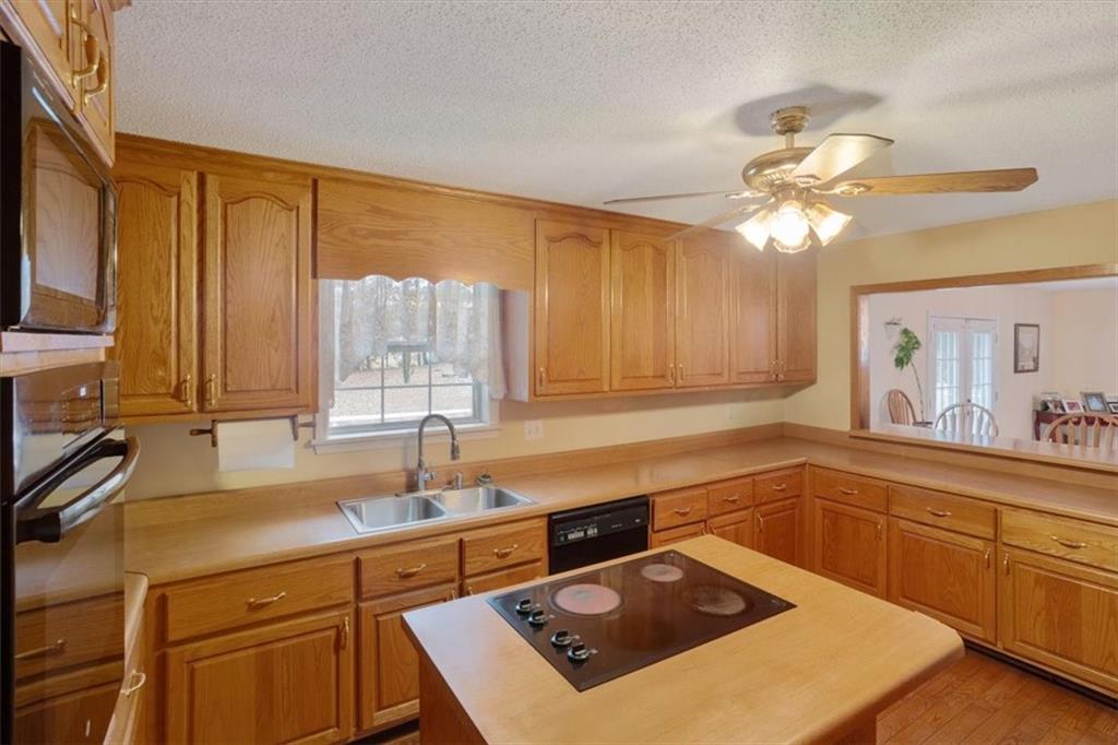 871 Robinson Road Chatsworth, GA 30705 - Photo 12 of 25 a kitchen with a sink a stove and cabinets