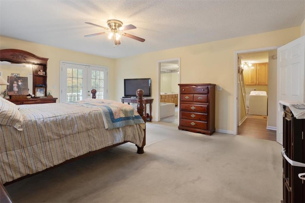 871 Robinson Road Chatsworth, GA 30705 - Photo 13 of 25 a bedroom with a bed and a chandelier