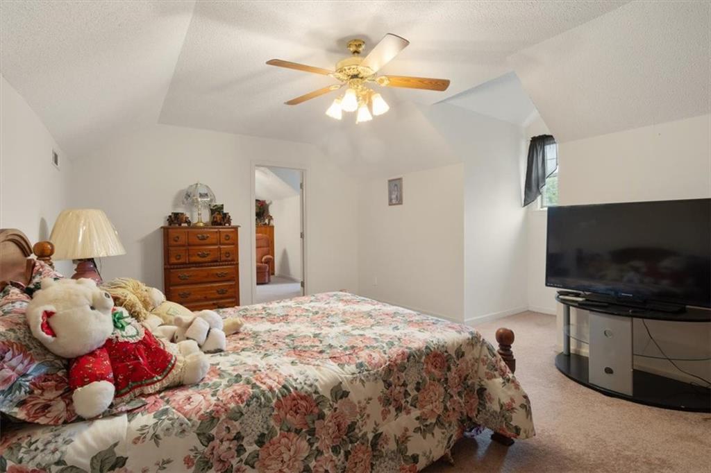 871 Robinson Road Chatsworth, GA 30705 - Photo 17 of 25 a bedroom with a bed and a flat screen tv