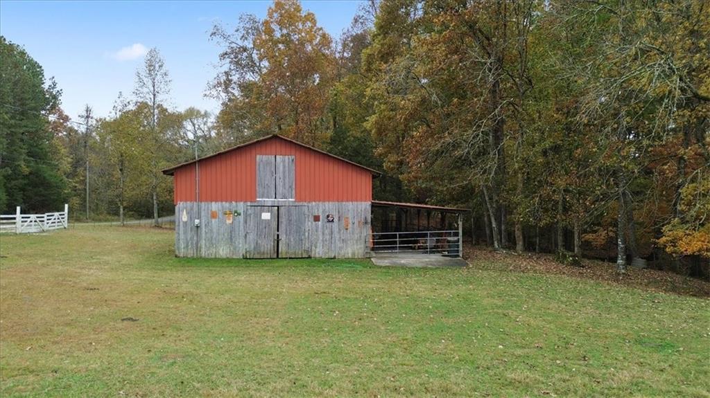 871 Robinson Road Chatsworth, GA 30705 - Photo 9 of 25 a view of a house with a yard and a wooden fence