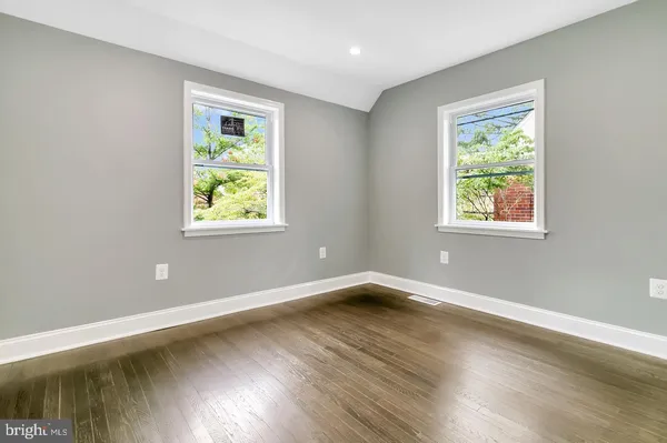 a view of a room with wooden floor and window